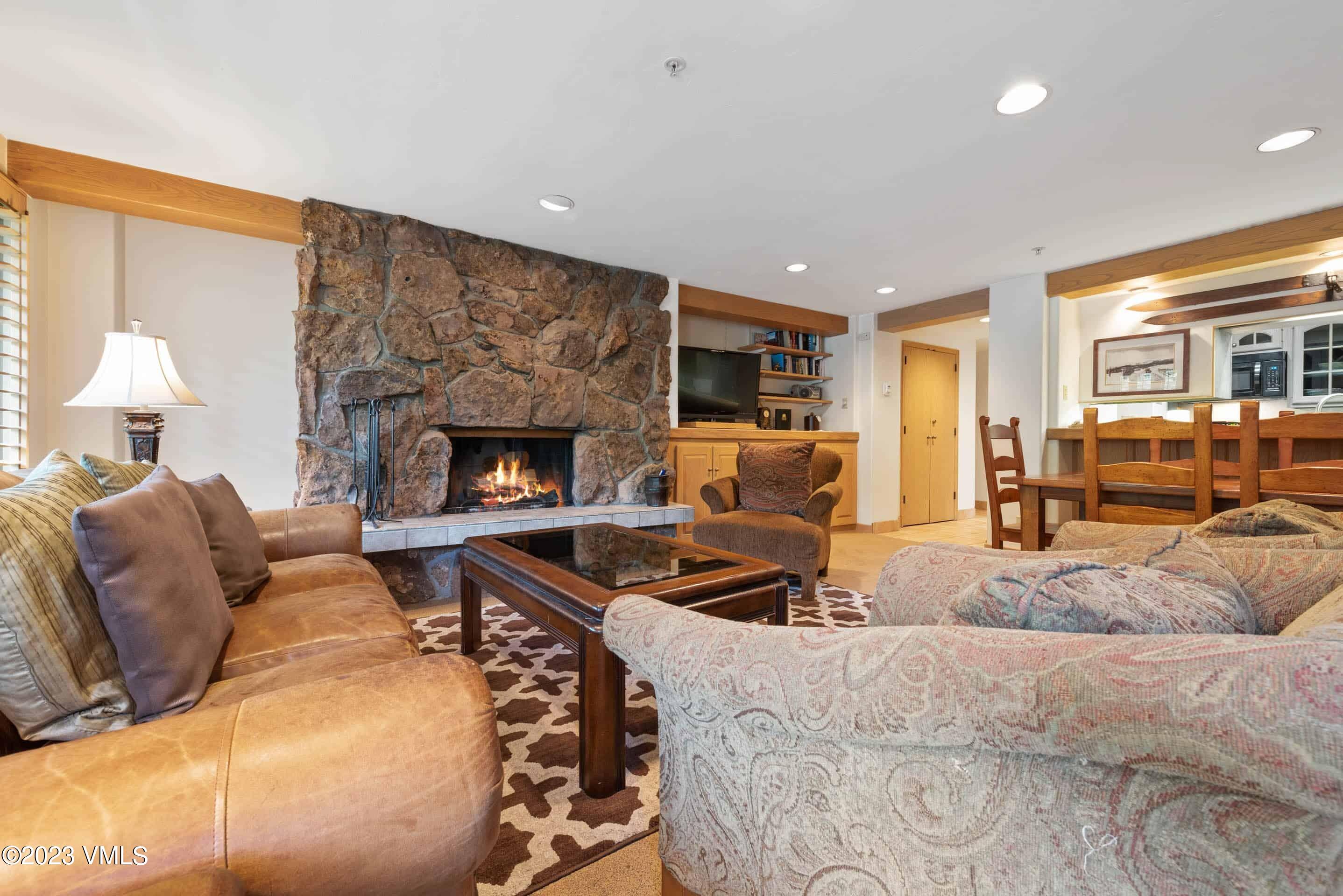 200 Vail Road, Unit 287 Vail, CO 81657 - Photo 6 of 21 a living room with furniture and a fireplace