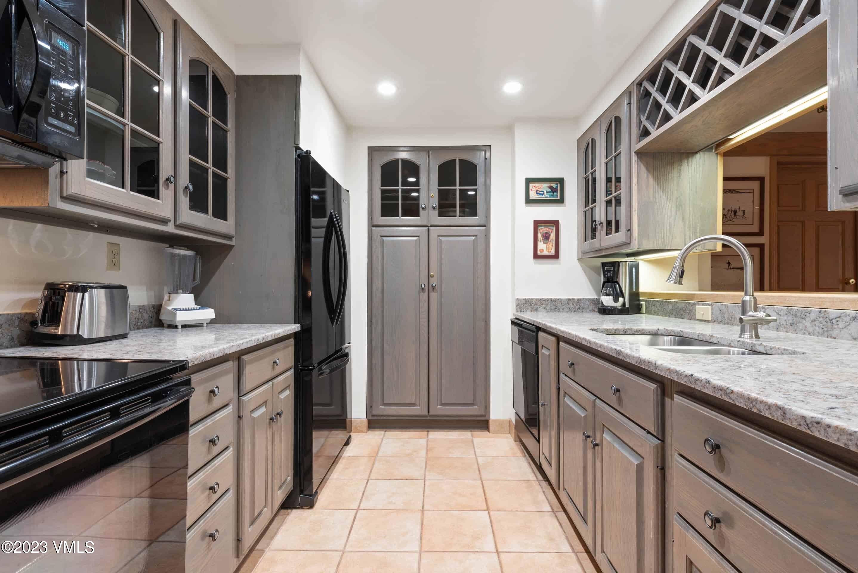200 Vail Road, Unit 287 Vail, CO 81657 - Photo 8 of 21 a kitchen with stainless steel appliances granite countertop a refrigerator and a sink
