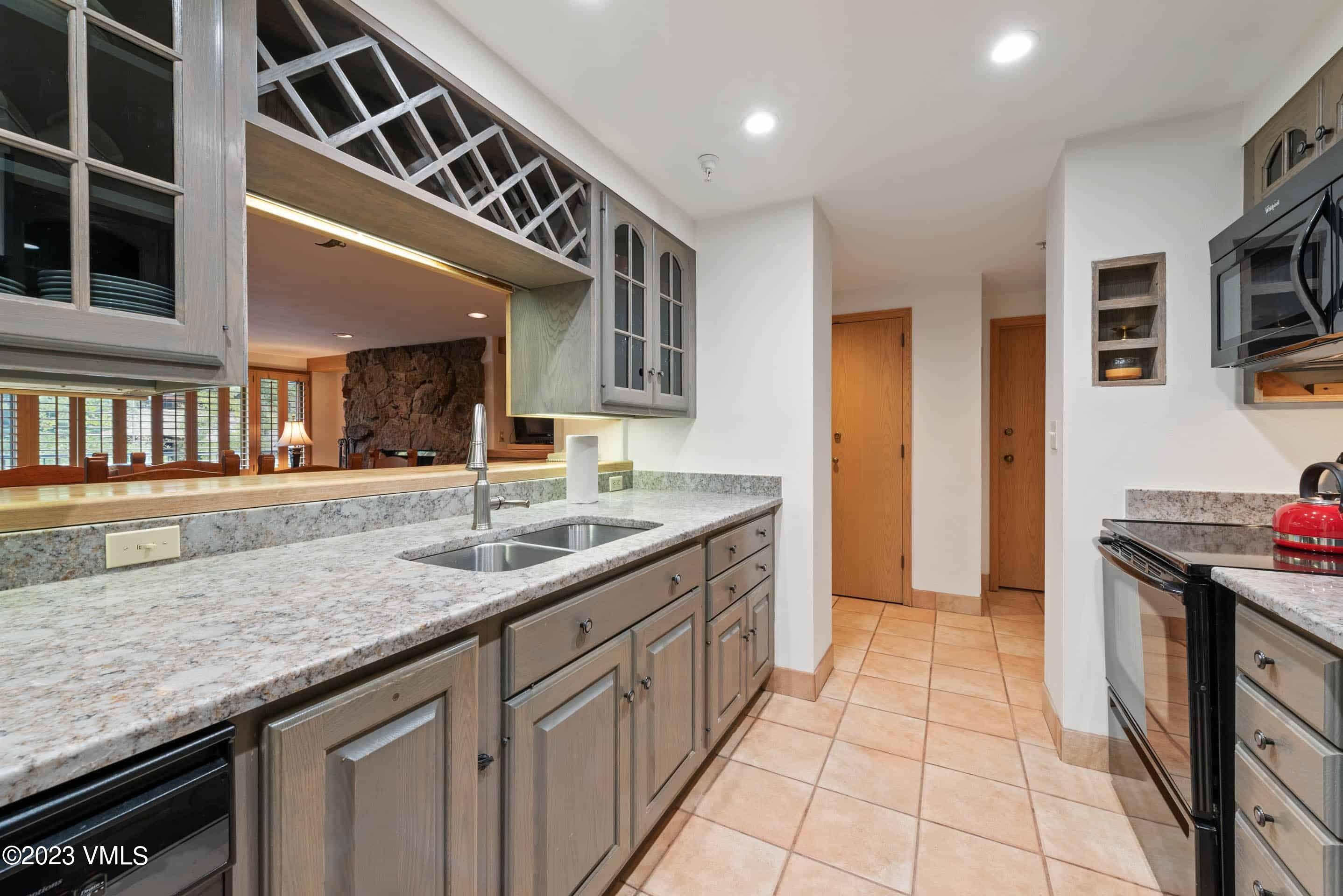 200 Vail Road, Unit 287 Vail, CO 81657 - Photo 9 of 21 a kitchen with stainless steel appliances granite countertop a sink and cabinets