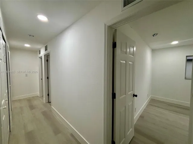 view of a hallway with wooden floor