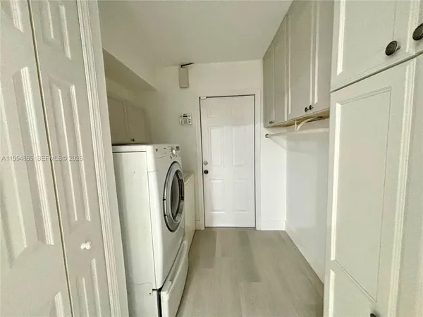 a view of a storage and utility room with washer and dryer