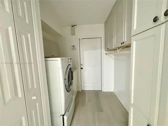 a view of a storage and utility room with washer and dryer
