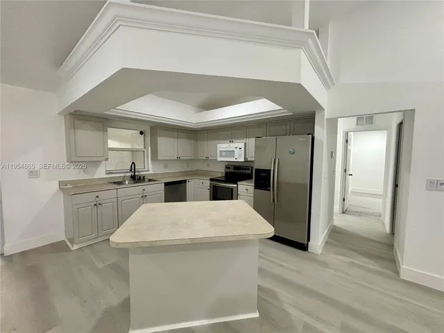 a kitchen with a sink and refrigerator