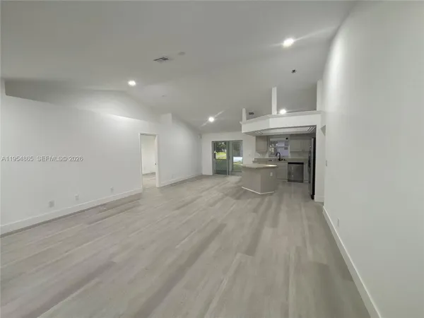 a view of a kitchen with a sink and cabinets