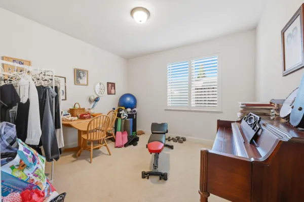 a view of a workspace with furniture and a window