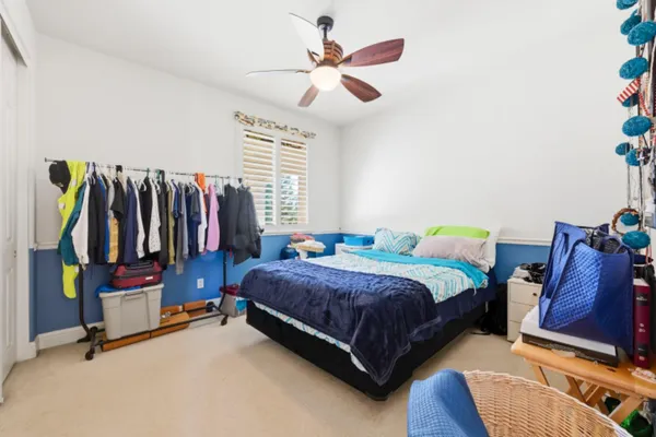 a bedroom with a bed a couch and a chandelier