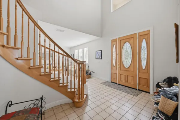a view of entryway with wooden floor and stairs