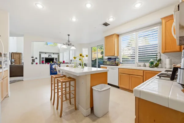a kitchen that has a lot of cabinets in it and appliances