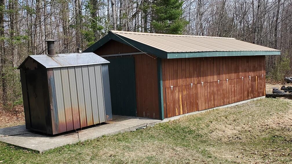 393 Anson Road Starks, ME 04911 - Photo 50 of 69 exterior woodshed and wood furnace 2