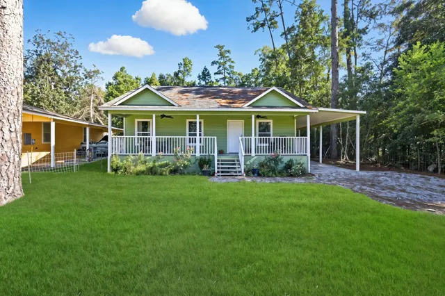 a front view of a house with a garden and porch