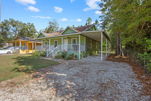 a view of a house with yard and a garden