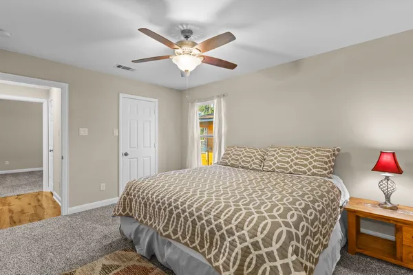 a bedroom with a bed and a chandelier