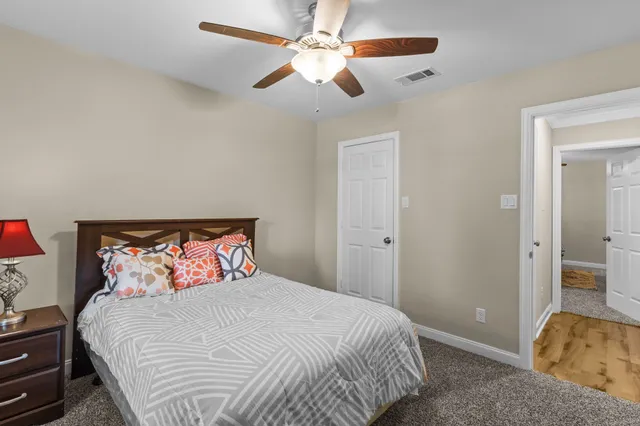 a bedroom with a bed and a ceiling fan