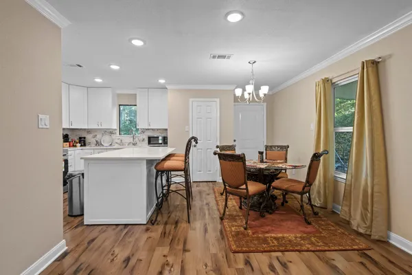 a view of a dining room with furniture and chandelier