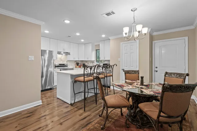 a view of kitchen with refrigerator dining table and chairs