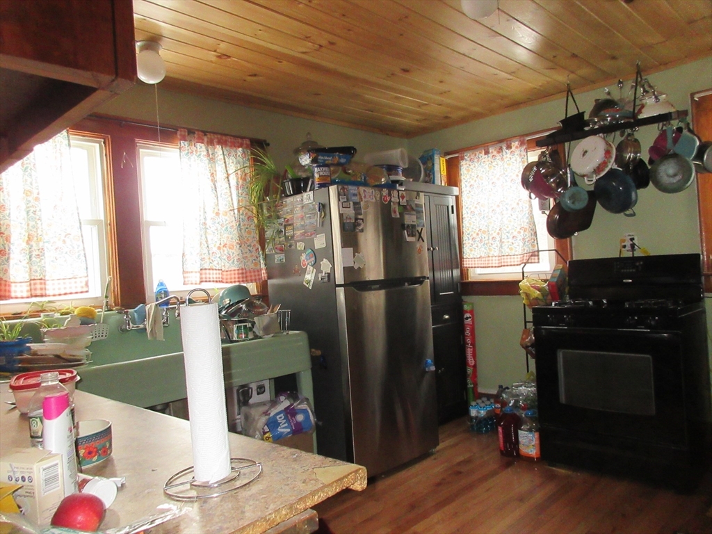 78 Main Street Blandford, MA 01008 - Photo 3 of 8 a kitchen with a refrigerator and a stove