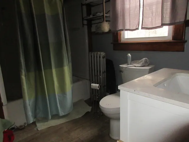 a bathroom with a sink a toilet and a mirror