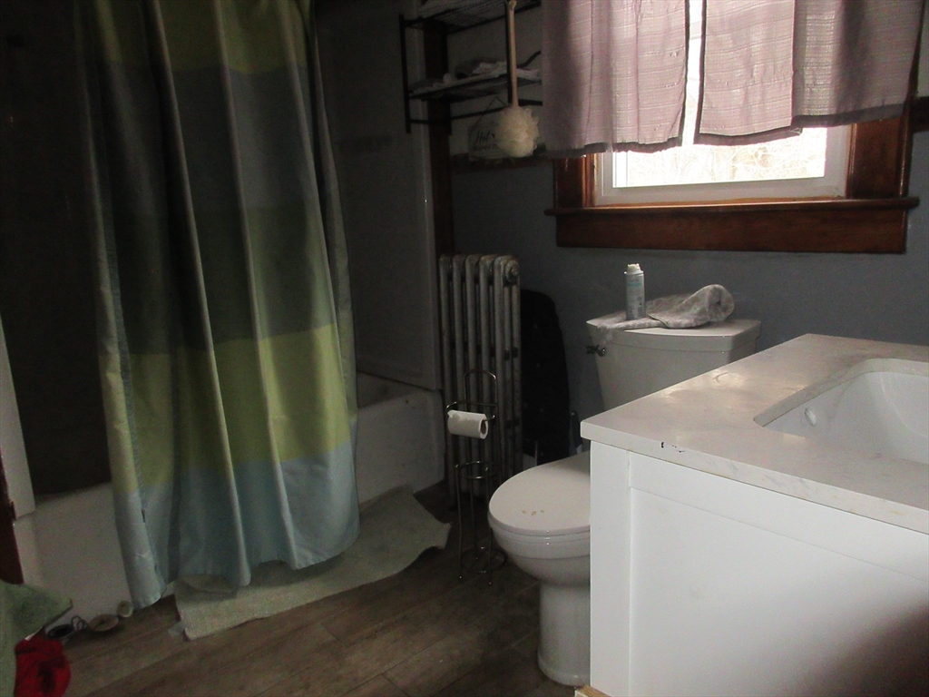 78 Main Street Blandford, MA 01008 - Photo 6 of 8 a bathroom with a sink a toilet and a mirror