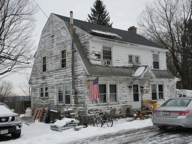 a car parked in front of white house