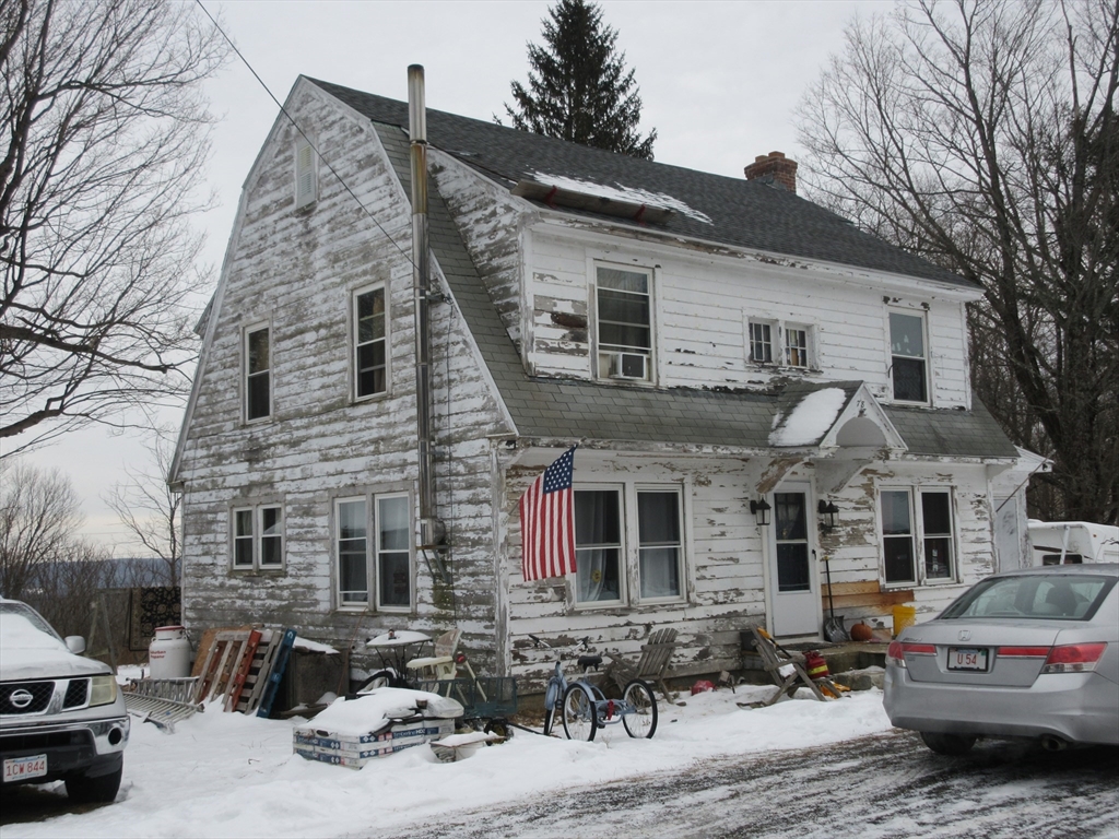 78 Main Street Blandford, MA 01008 - Photo 8 of 8 a car parked in front of white house