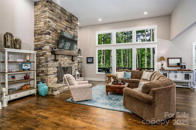 a living room with fireplace furniture and a large window