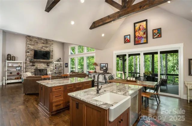 a view of a kitchen with kitchen island granite countertop lots of counter top space