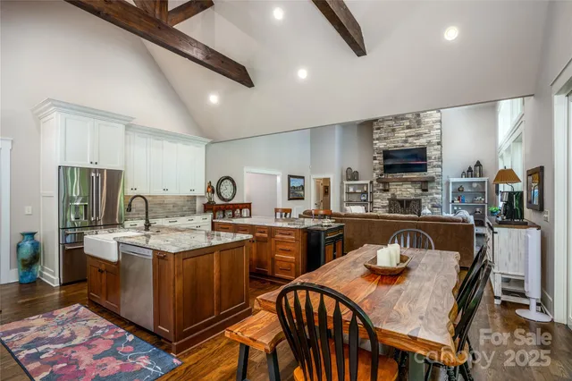 a kitchen with sink a refrigerator and chairs