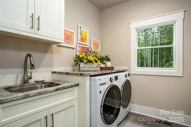 a utility room with sink dryer and washer
