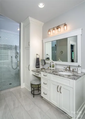 a spacious bathroom with a shower sink double and mirror