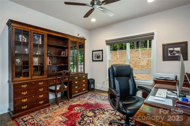 a livingroom with workspace and a window