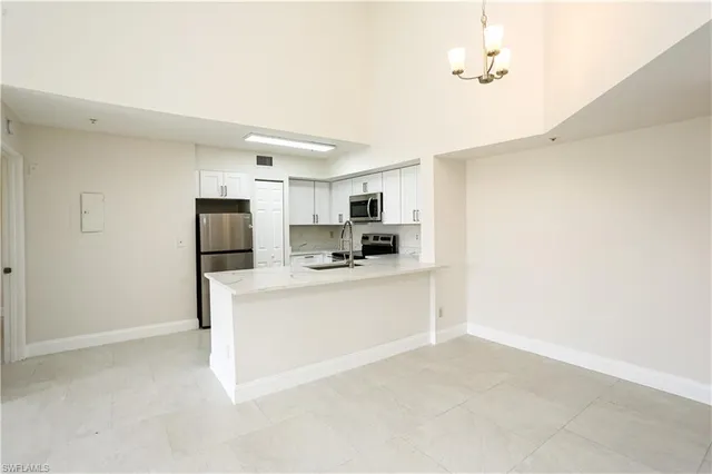 a kitchen with stainless steel appliances a refrigerator and a stove top oven