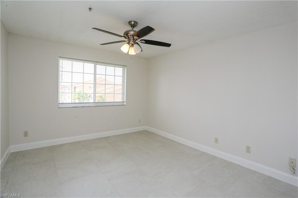 1265 Wildwood Lakes Boulevard, Unit 3306 Naples, FL 34104 - Photo 15 of 39 an empty room with a window