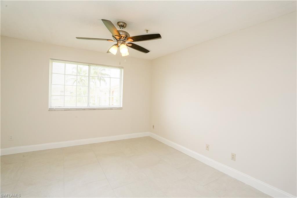 1265 Wildwood Lakes Boulevard, Unit 3306 Naples, FL 34104 - Photo 26 of 39 an empty room with a window