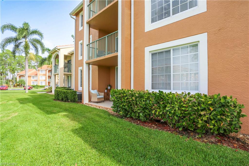 1265 Wildwood Lakes Boulevard, Unit 3306 Naples, FL 34104 - Photo 31 of 39 a front view of a house with a garden