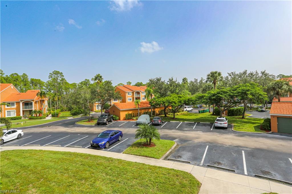 1265 Wildwood Lakes Boulevard, Unit 3306 Naples, FL 34104 - Photo 38 of 39 a view of a house with a yard