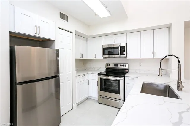 a kitchen with a refrigerator sink and microwave