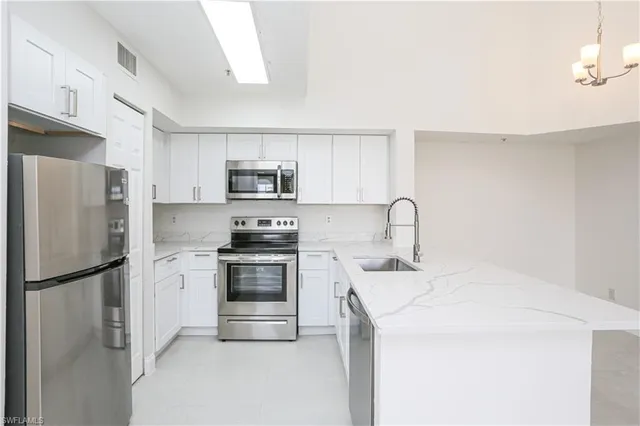 a kitchen with a refrigerator sink and white stove