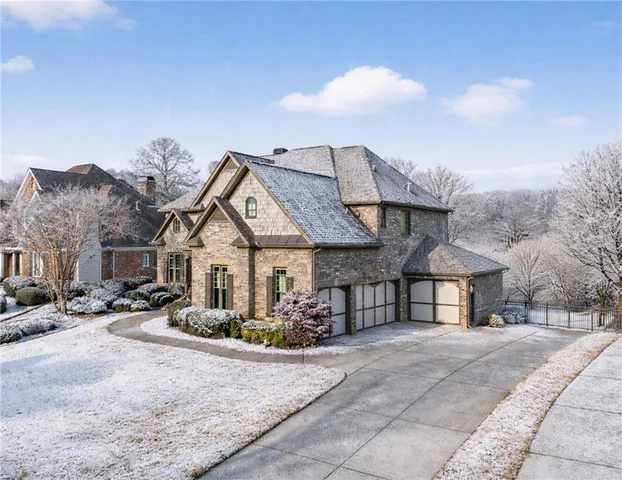 a living room with furniture a large window and a fireplace