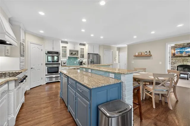 a spacious bathroom with a granite countertop sink and a mirror