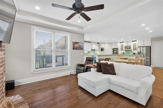 a living room with furniture and wooden floor