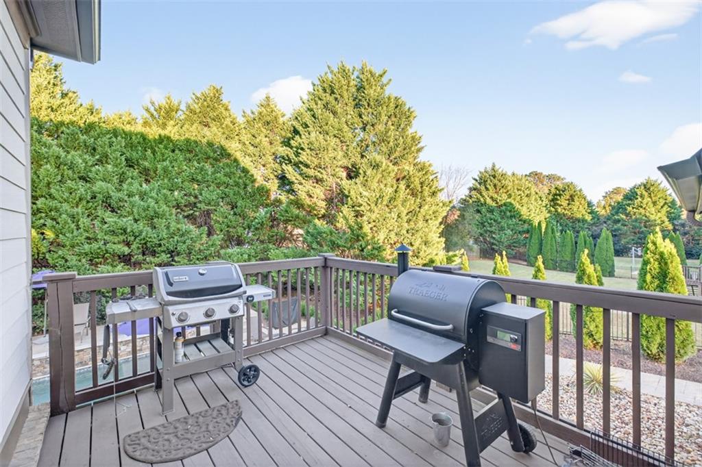 909 Pathview Court Dacula, GA 30019 - Photo 27 of 113 a balcony with wooden floor table and chairs