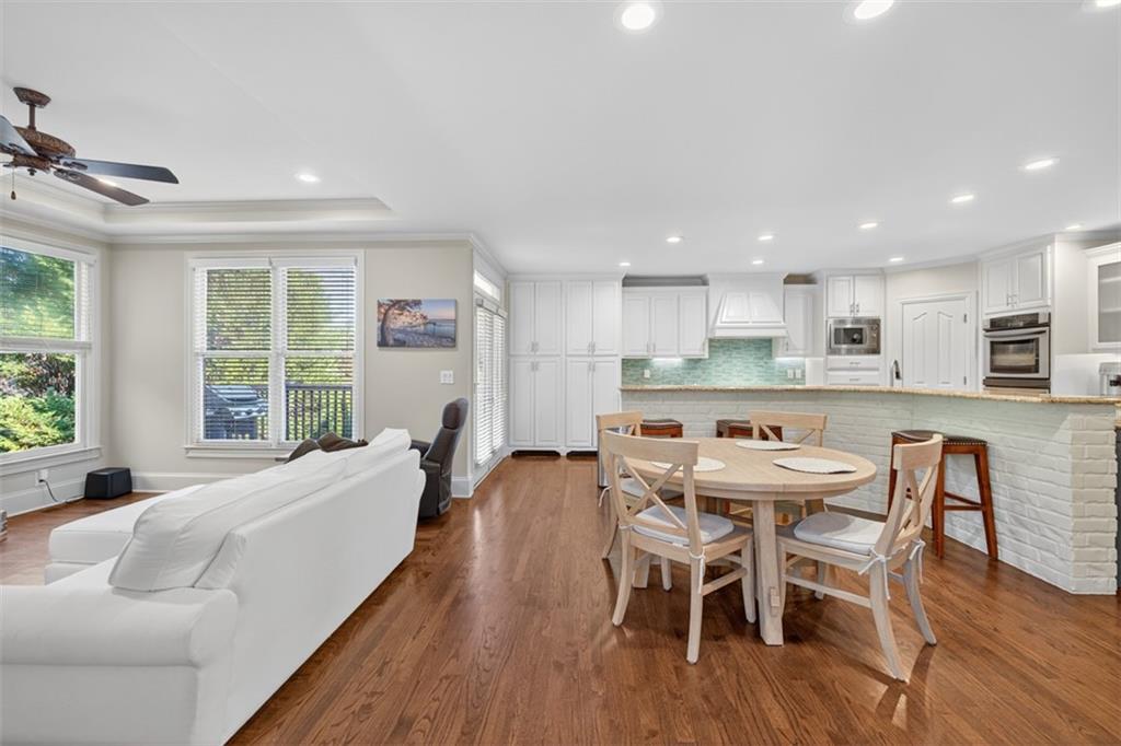 909 Pathview Court Dacula, GA 30019 - Photo 29 of 113 a dining room with furniture and wooden floor
