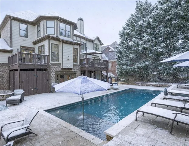 a living room with furniture fireplace and a large window