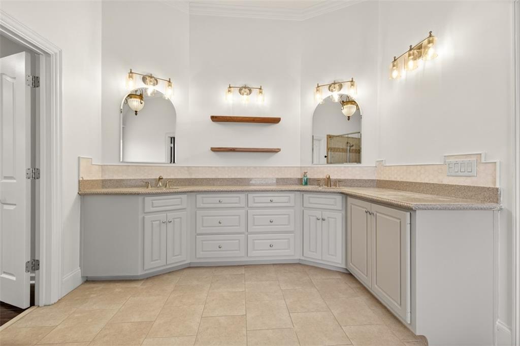 909 Pathview Court Dacula, GA 30019 - Photo 50 of 113 a spacious bathroom with a granite countertop sink and a mirror