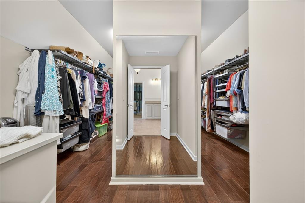 909 Pathview Court Dacula, GA 30019 - Photo 54 of 113 a view of a hallway with wooden floor and furniture