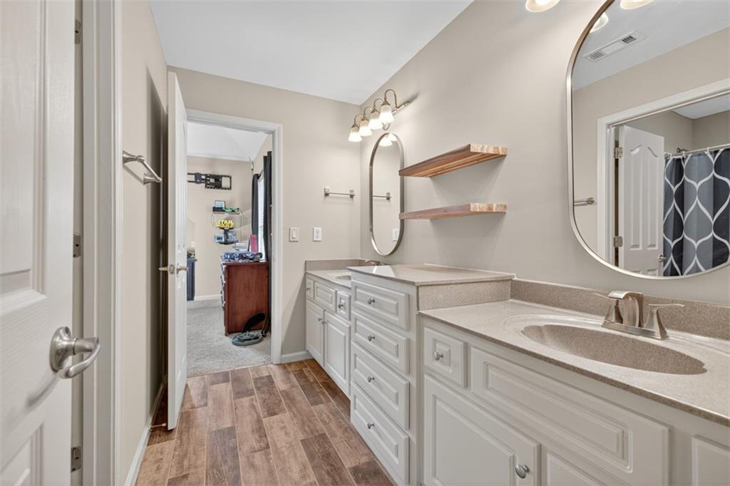 909 Pathview Court Dacula, GA 30019 - Photo 59 of 113 a en suite bathroom with a double vanity sink and a mirror