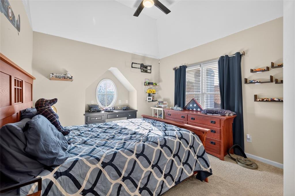 909 Pathview Court Dacula, GA 30019 - Photo 61 of 113 a bedroom with a bed and a chandelier