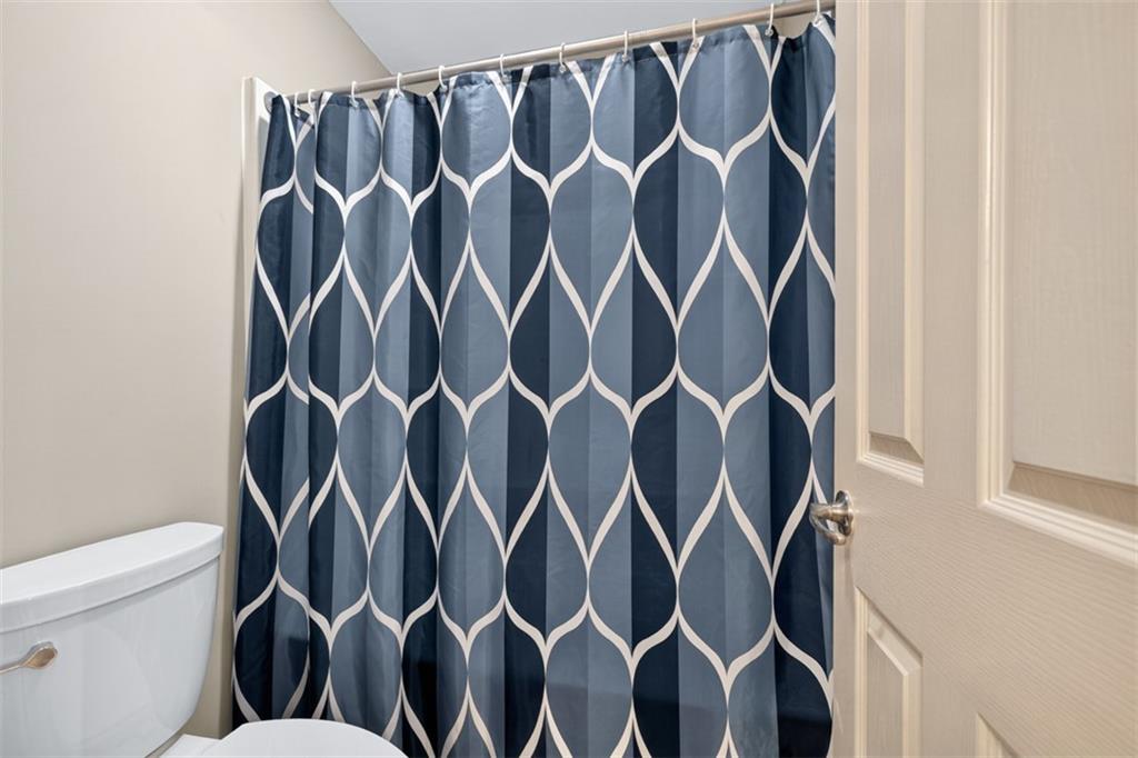 909 Pathview Court Dacula, GA 30019 - Photo 62 of 113 a bathroom with a shower curtain and a sink