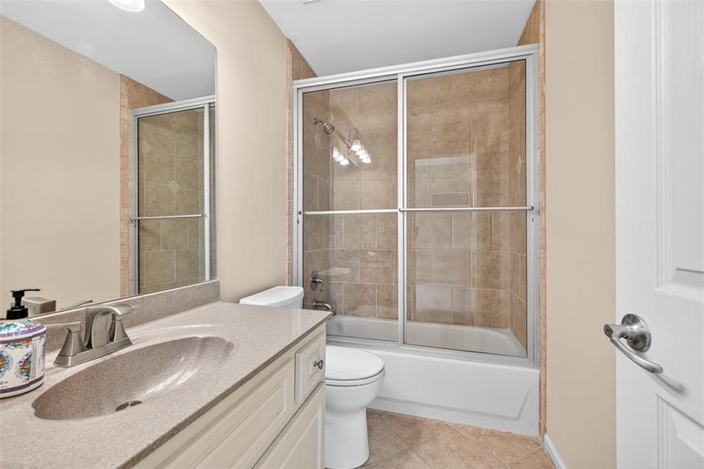 909 Pathview Court Dacula, GA 30019 - Photo 65 of 113 a bathroom with a granite countertop sink toilet and shower