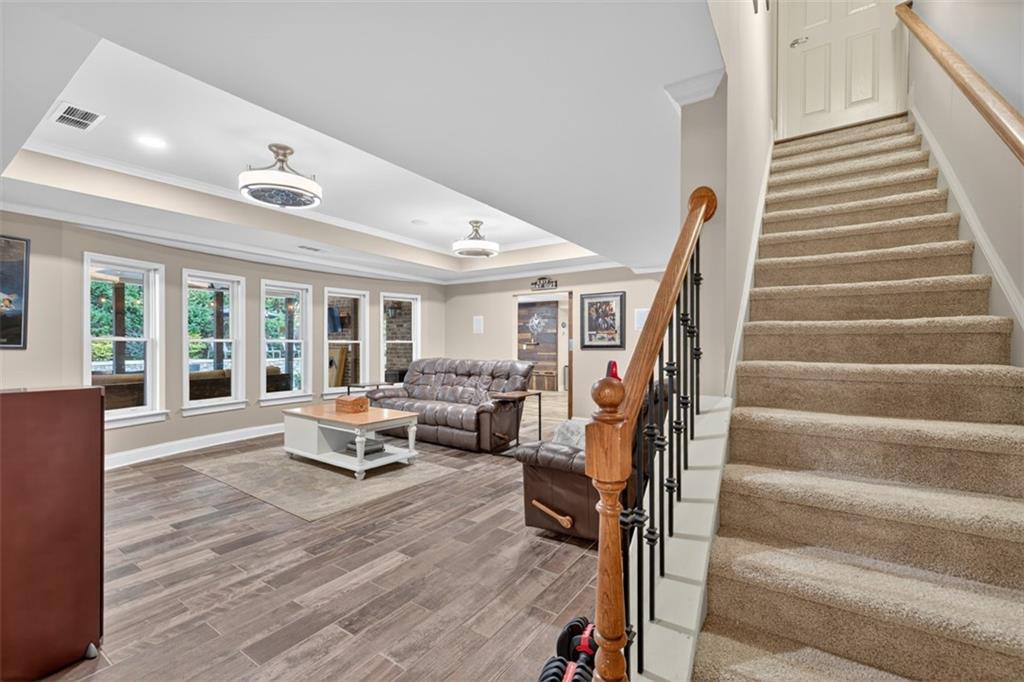 909 Pathview Court Dacula, GA 30019 - Photo 68 of 113 a living room with furniture and wooden floor